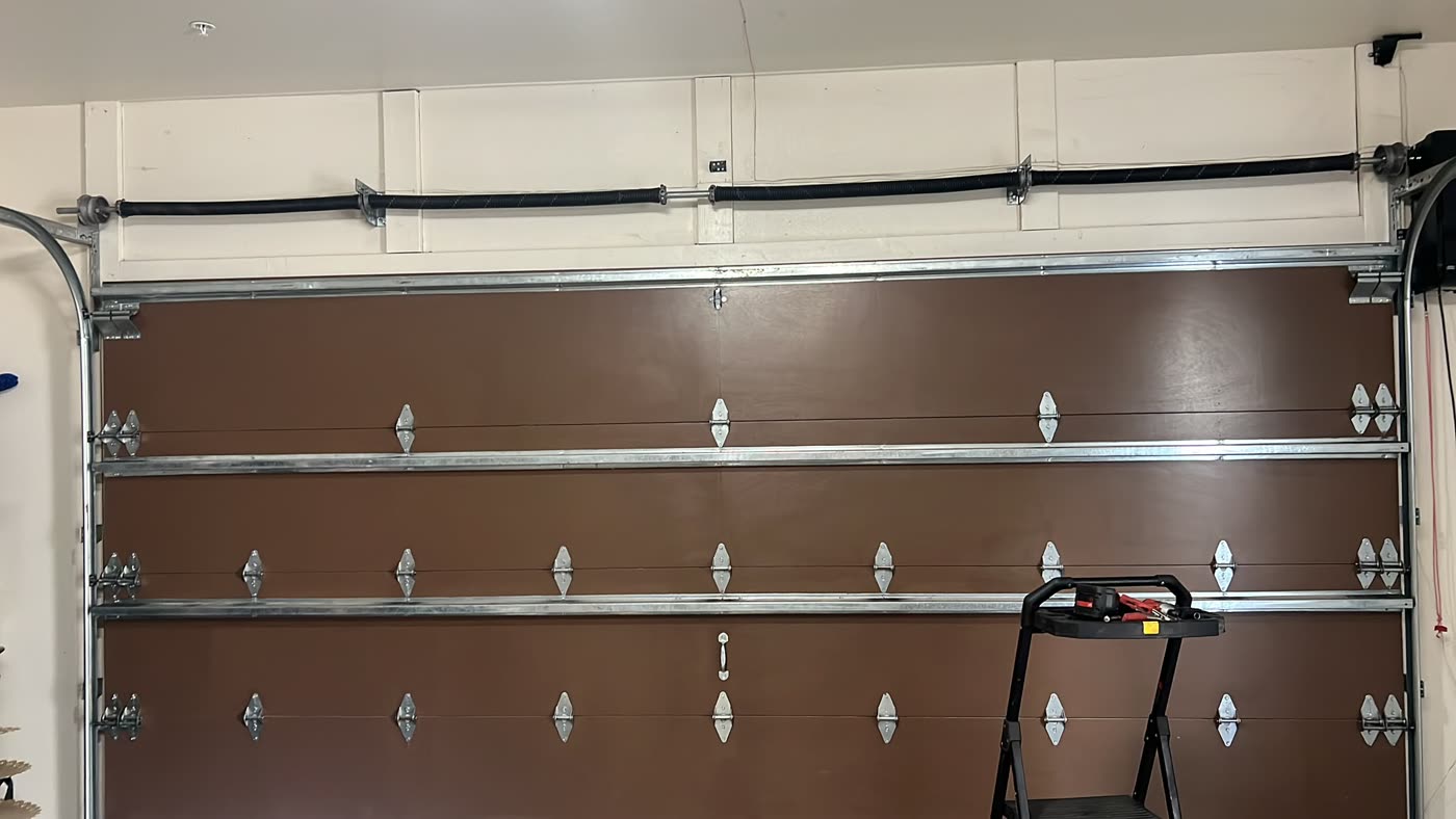 Brown garage door from inside with new torsion springs and hardware