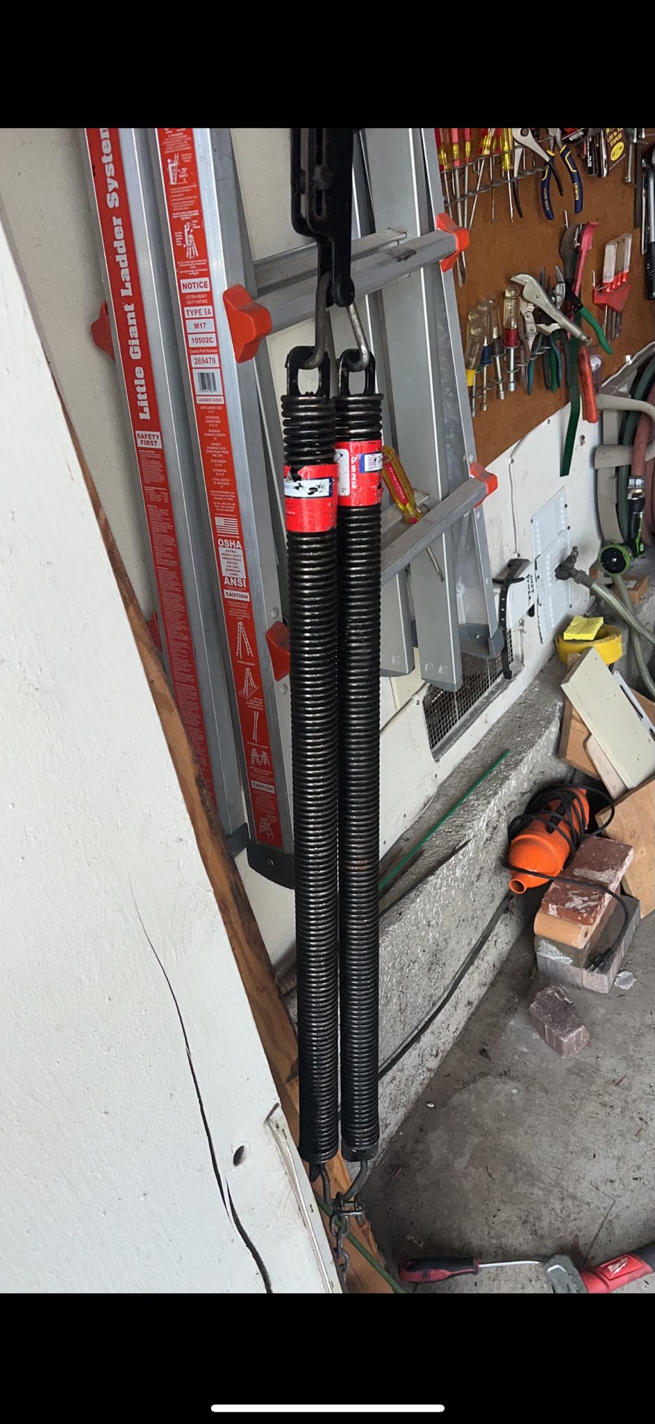New extension springs ready to be installed on a garage door