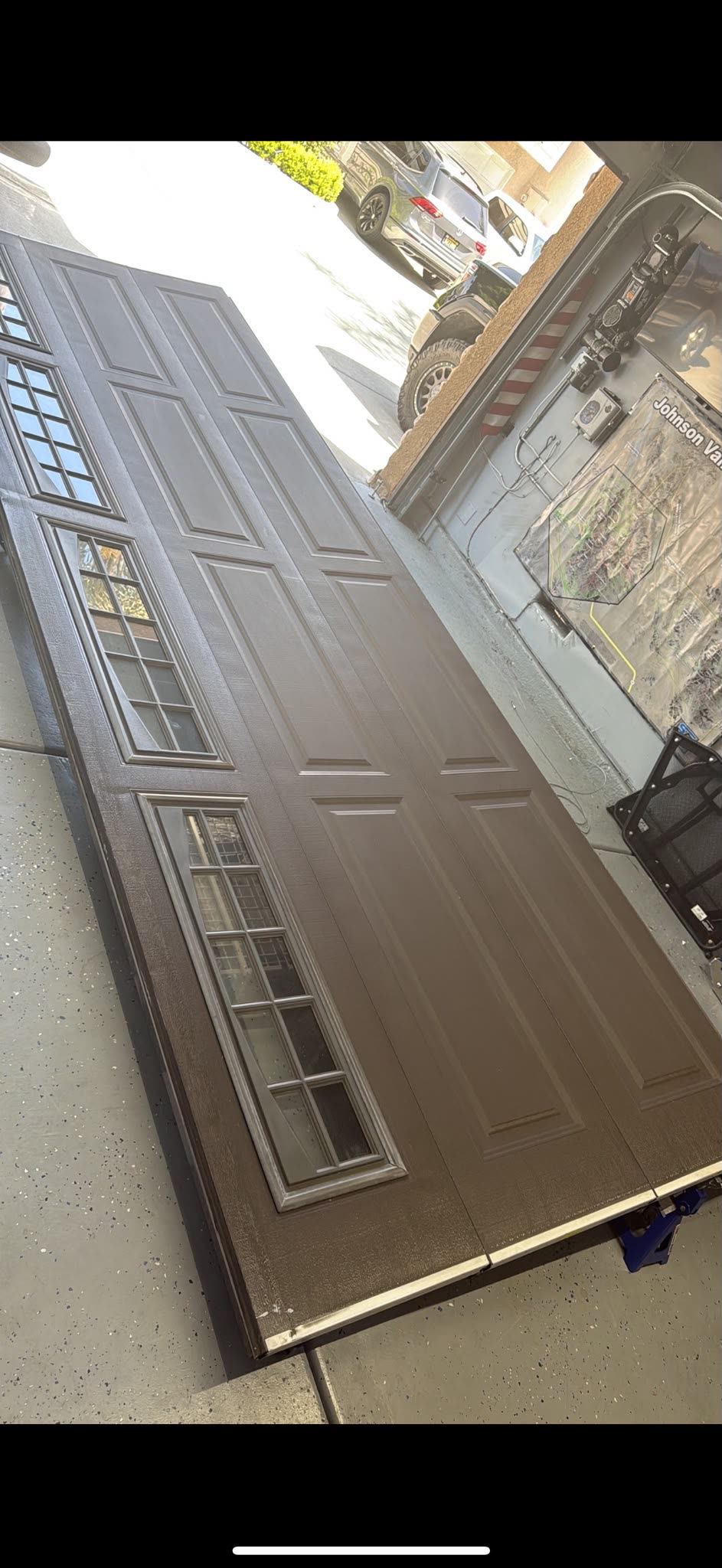 New carriage-style garage door sections prepped for installation