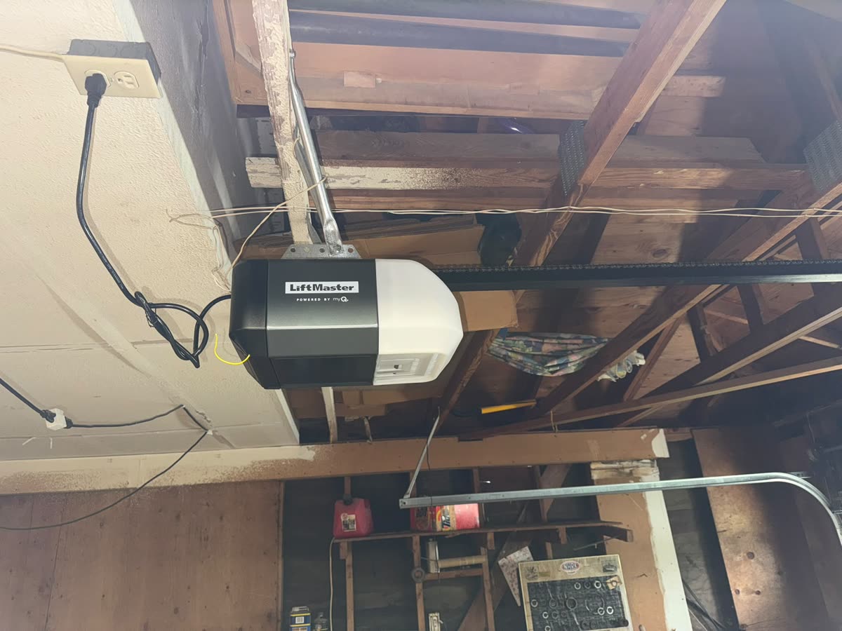 LiftMaster belt-drive opener installed in an older garage with exposed rafters