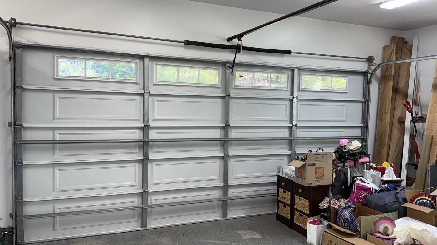 White raised-panel garage door with windows after full replacement