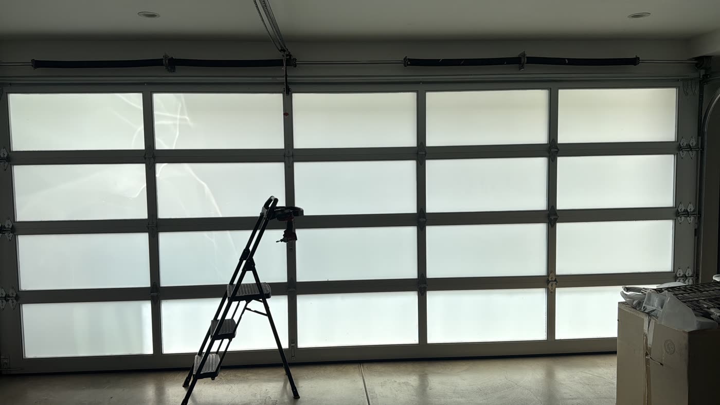 Modern full-view glass garage door installed by Decision Garage Doors