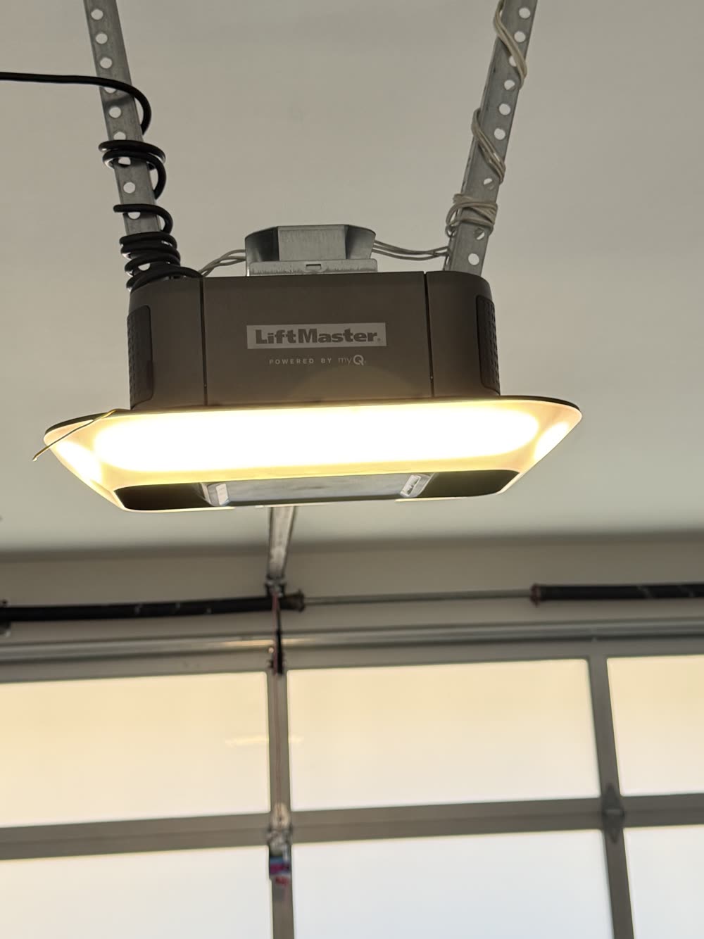 LiftMaster belt-drive opener installed over a glass garage door